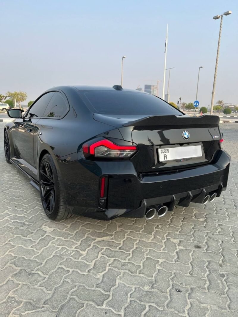 Dry carbon fiber trunk lip spoiler on BMW M2 G87, showcasing aerodynamic upgrade and premium craftsmanship
